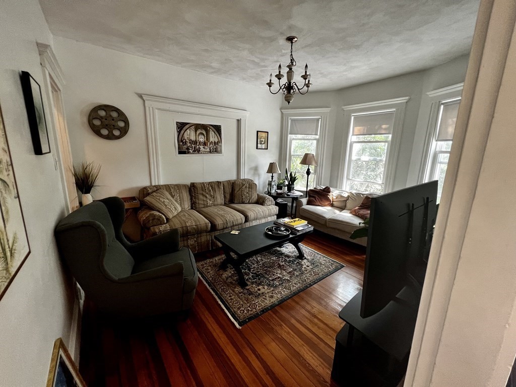 a living room with furniture rug and window