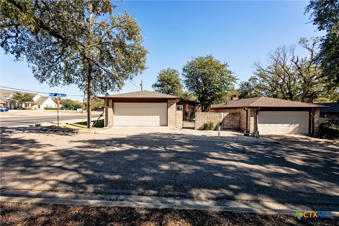 a view of a house with a yard and garage