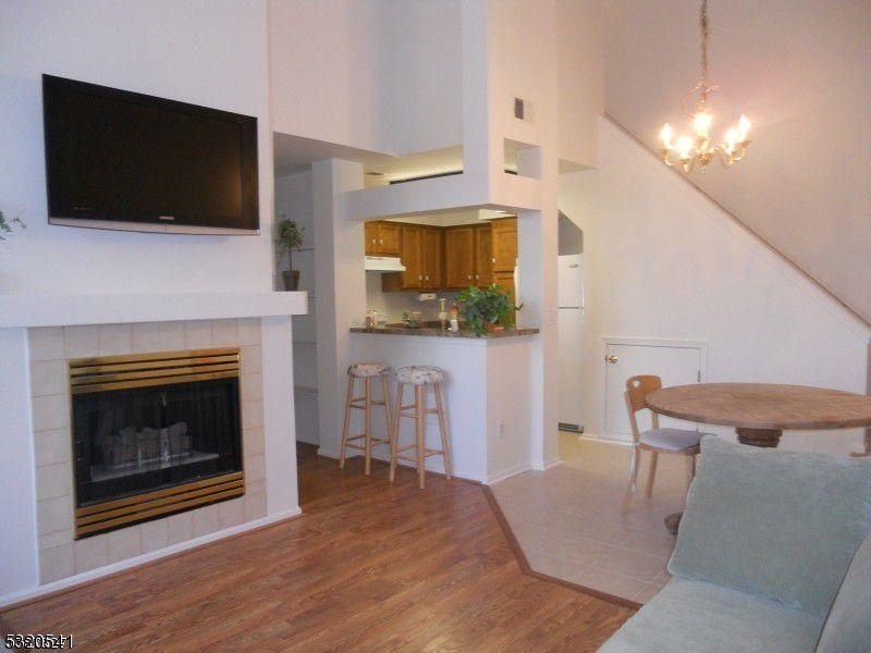 a living room with a fireplace and a flat screen tv