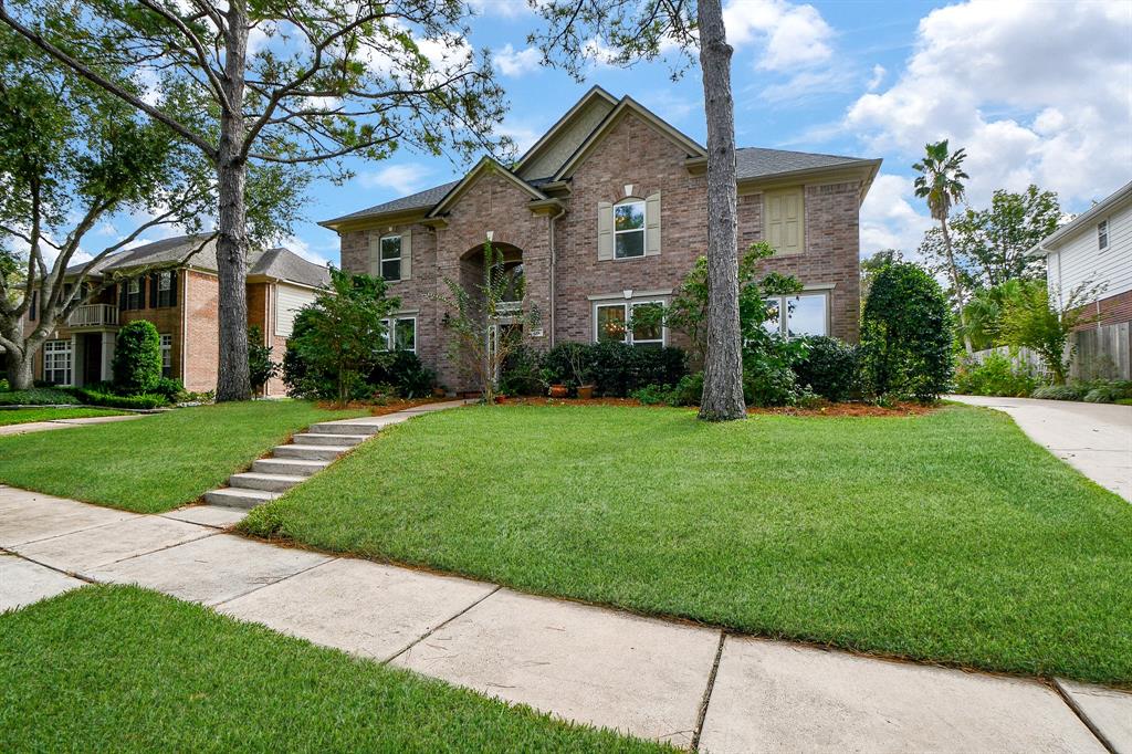 a front view of house with yard and green space