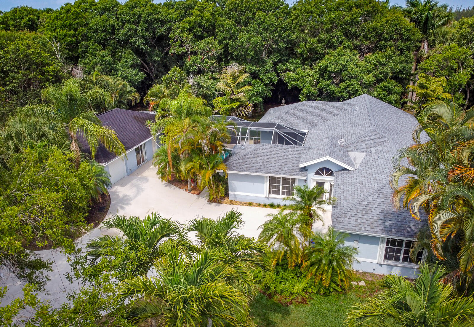 an aerial view of multiple houses with a yard