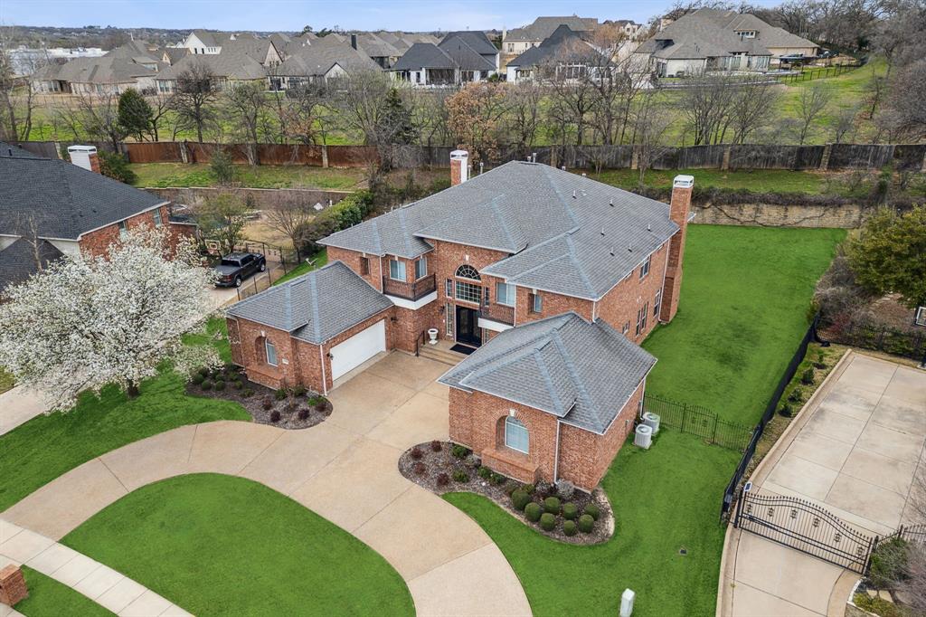 an aerial view of a house with a garden and lake view