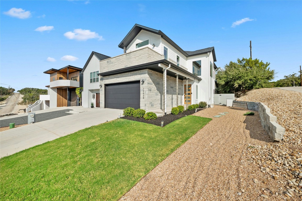 a front view of a house with a yard and garage