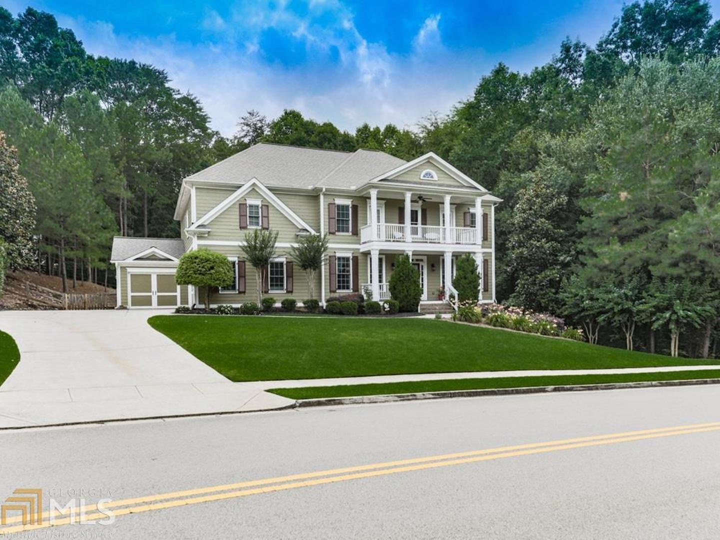 a front view of a house with a garden