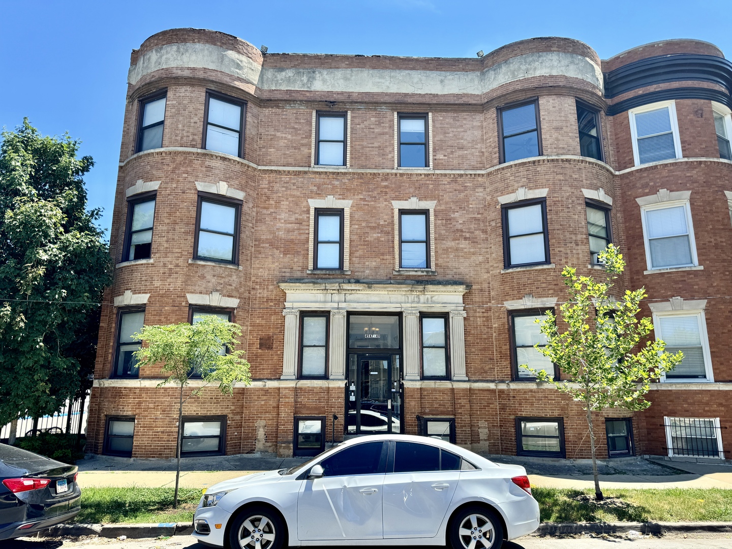 a front view of a building with parking space