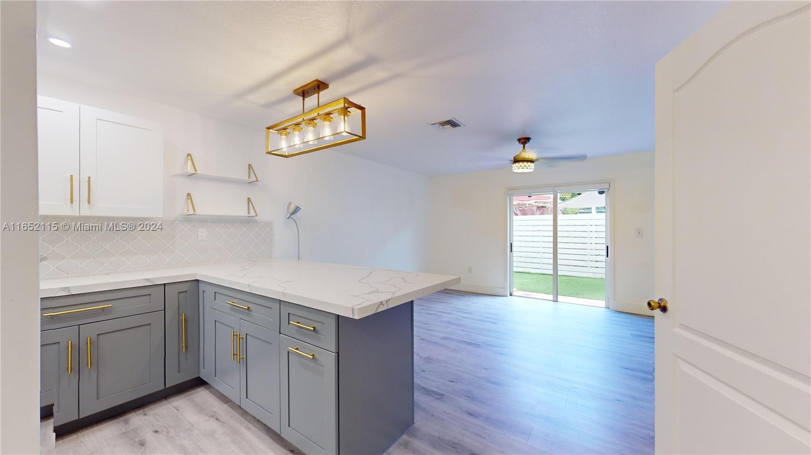 a kitchen with a sink cabinets and wooden floor