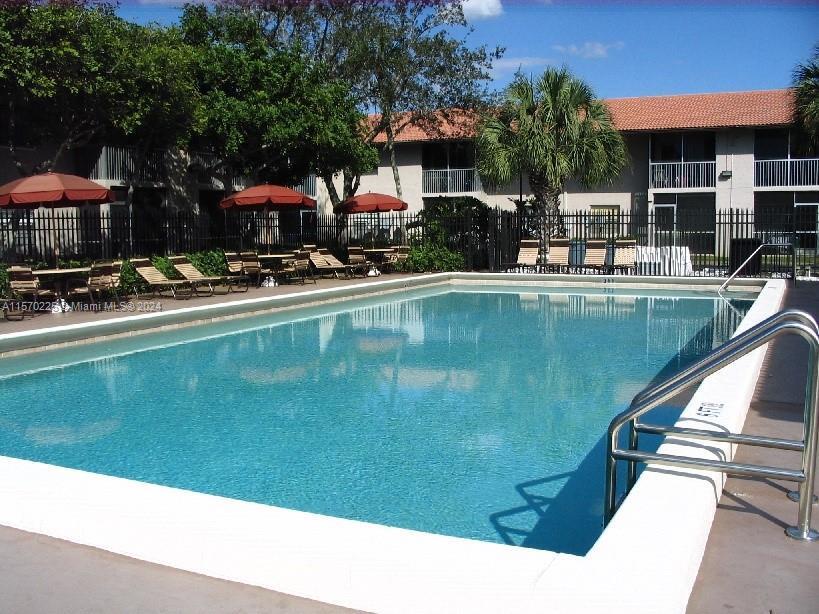 a swimming pool with outdoor seating and yard