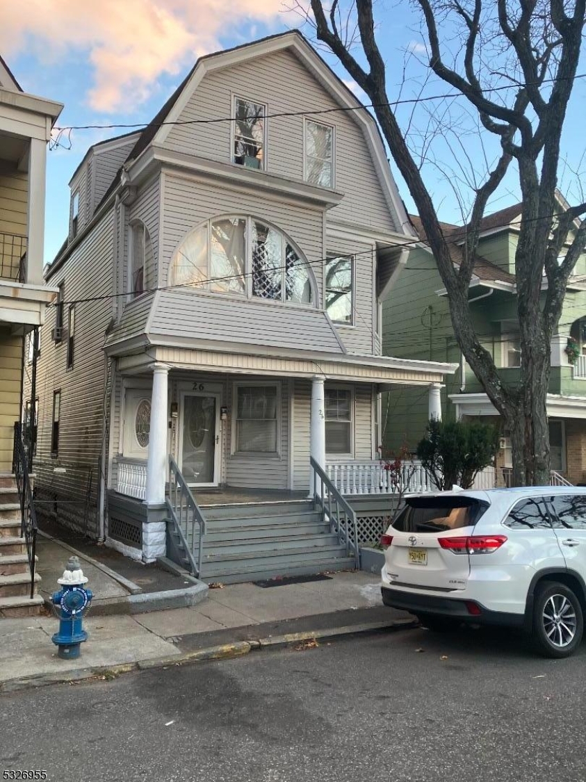 a front view of a house with parking area