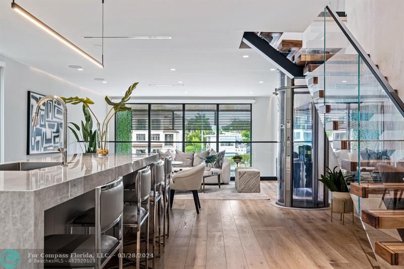 a very nice looking living room with a large window and wooden floor