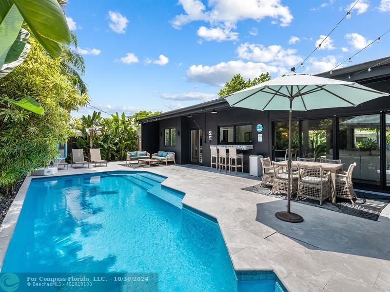 a view of a swimming pool with chairs in patio