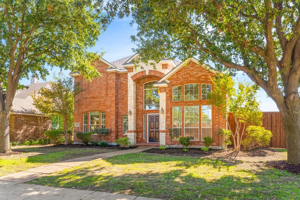 a view of a large trees in front of a house