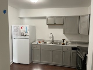 a kitchen with stainless steel appliances granite countertop a sink and a refrigerator