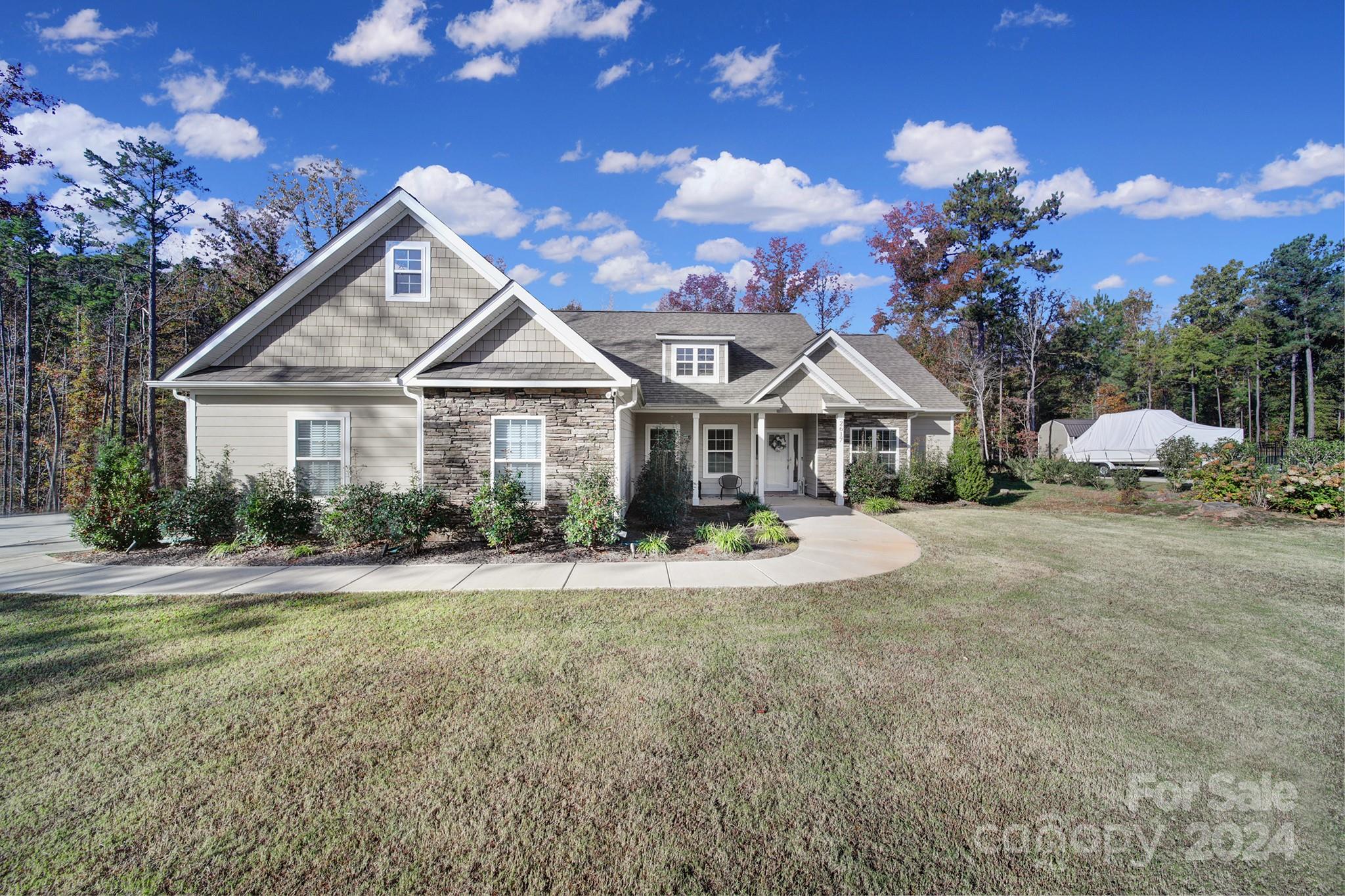 a front view of a house with garden and porch