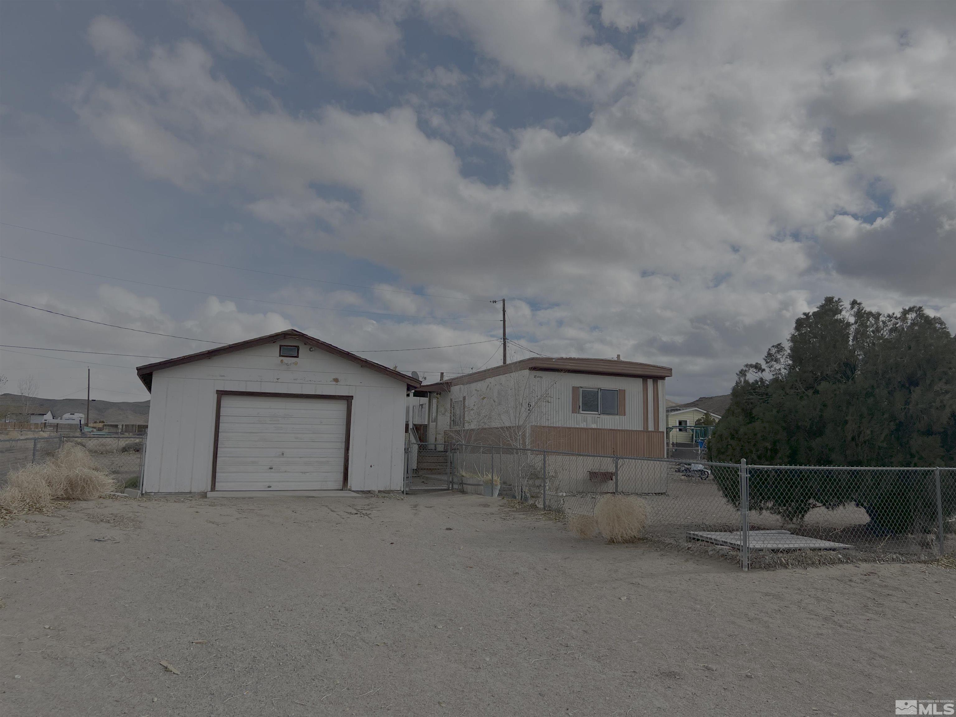 a view of a house with wooden fence