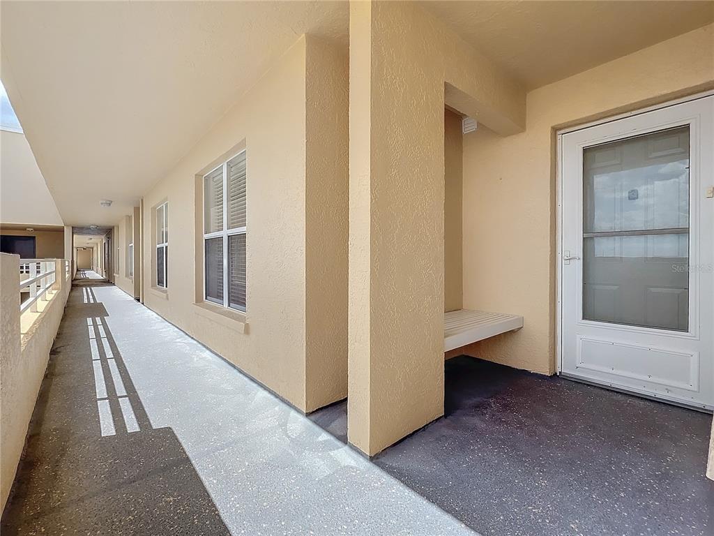 a view of a hallway with a furniture and front door