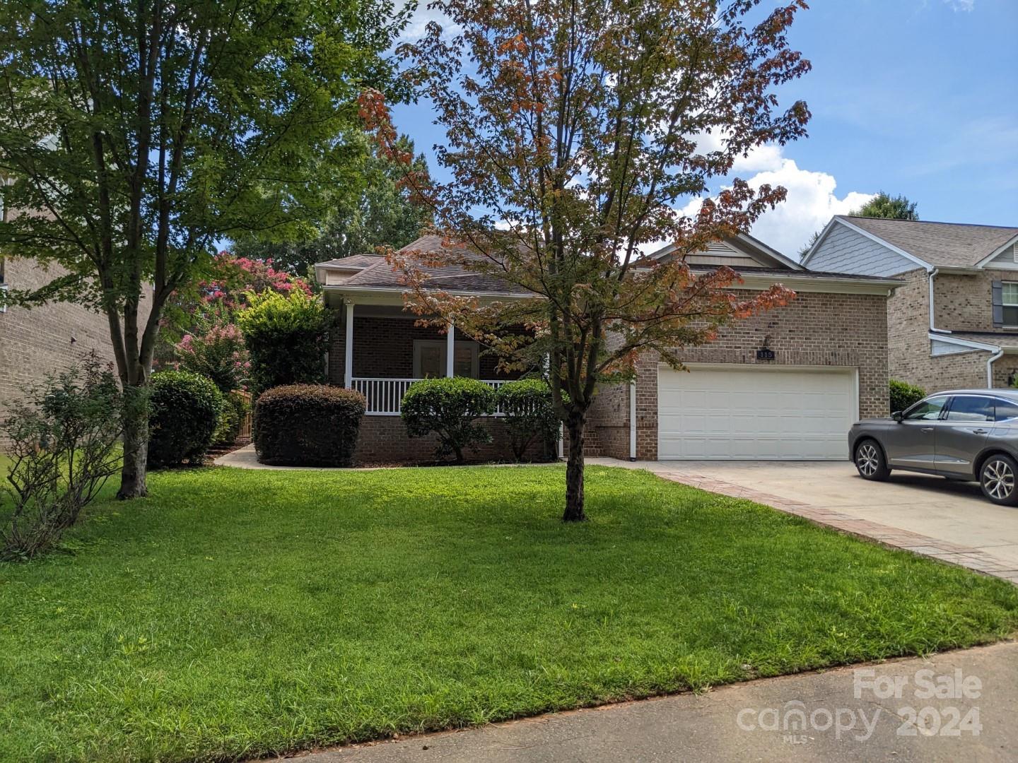 a view of a house with a backyard and a tree