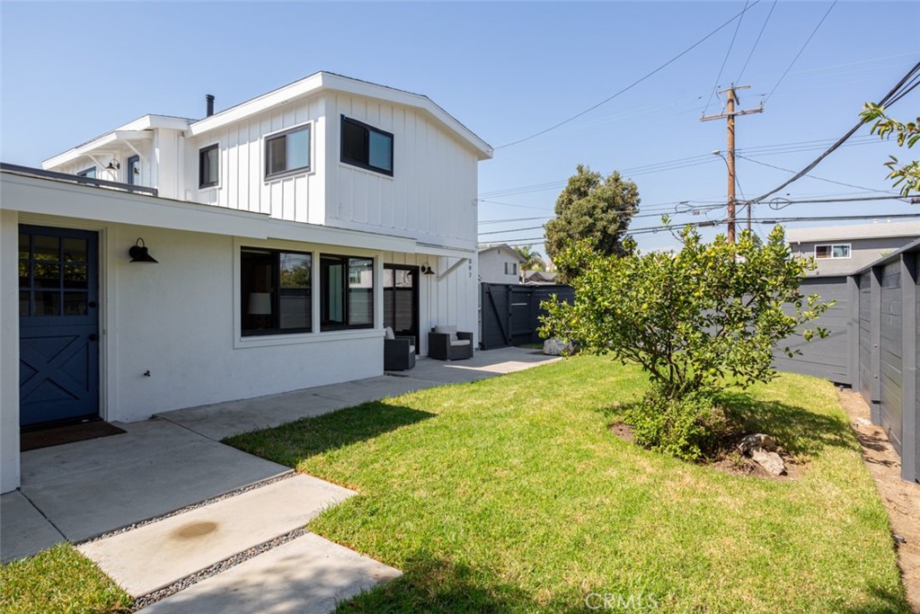 a front view of a house with a yard and potted plants