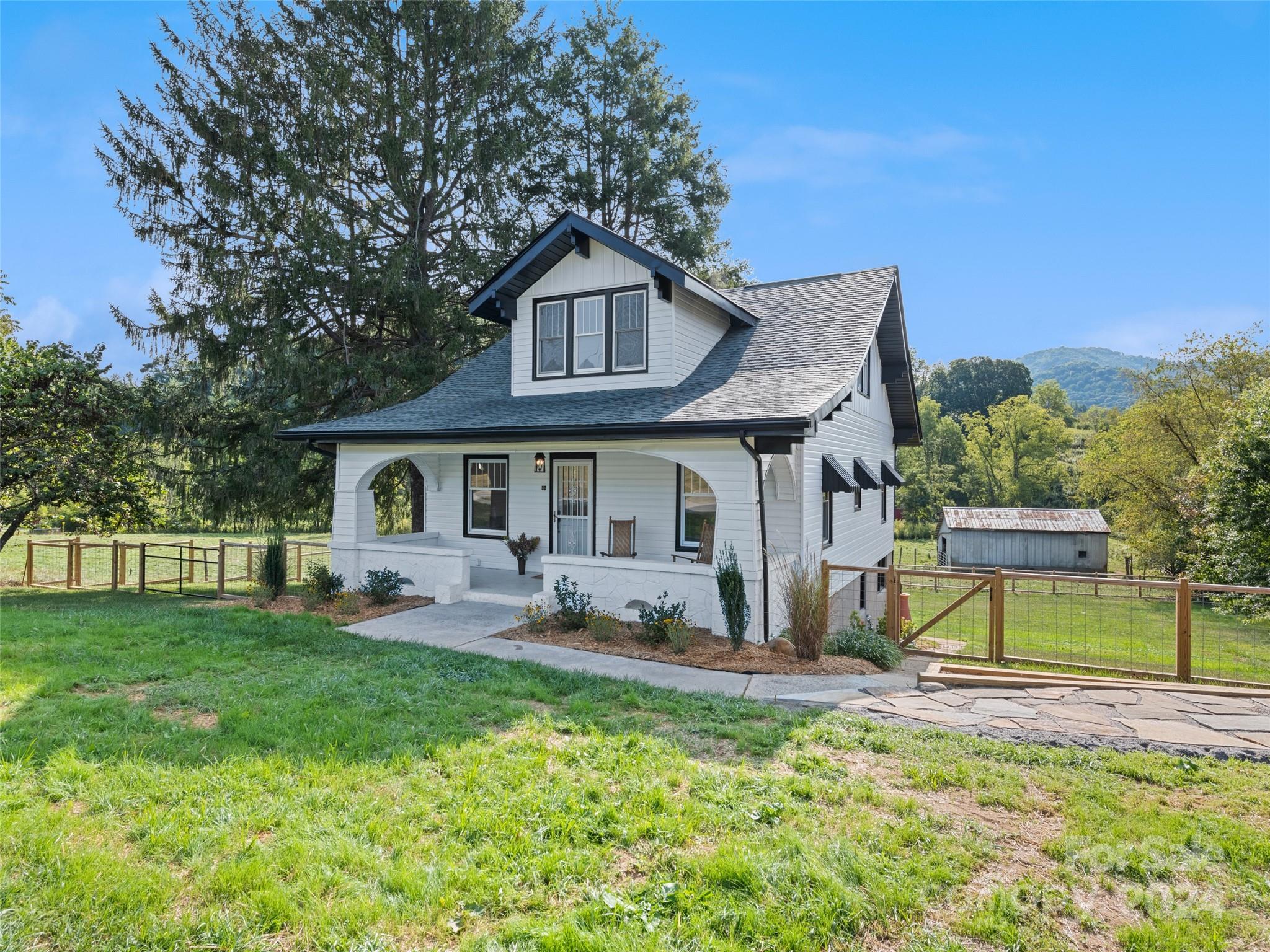 a front view of house with yard and outdoor seating