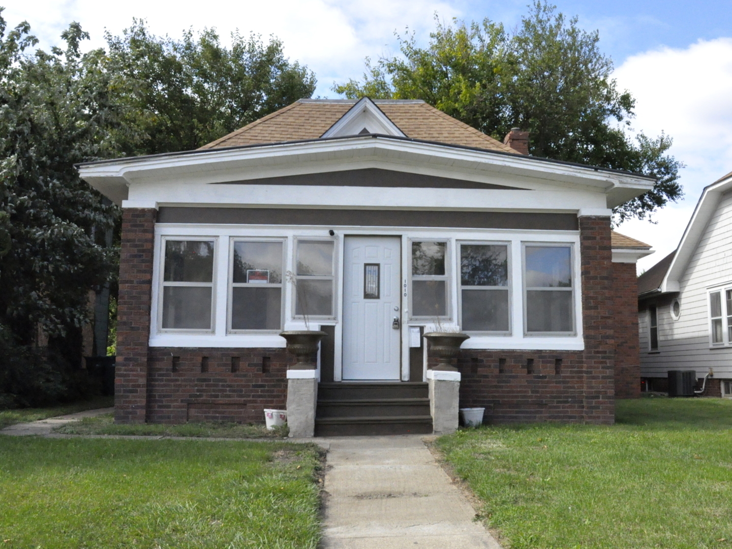 a front view of a house with a garden