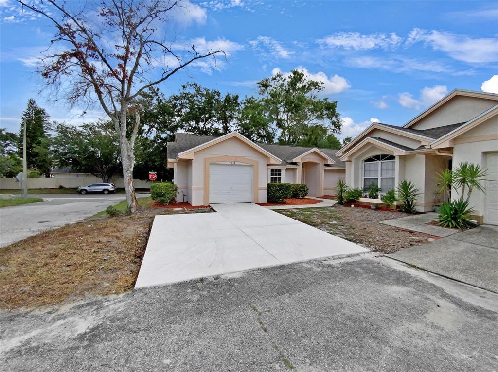 a front view of a house with a yard and trees