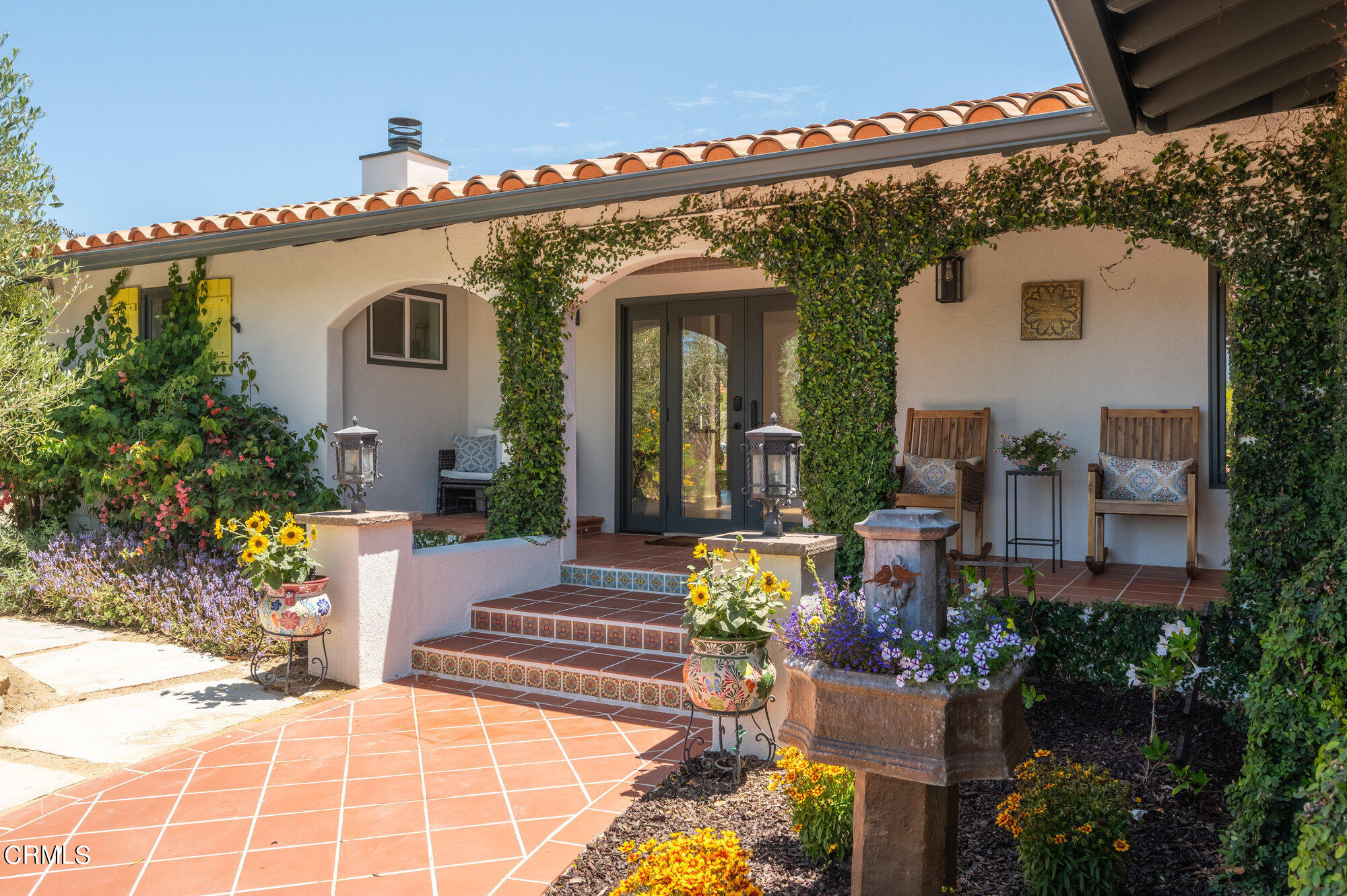 a view of a house with potted plants