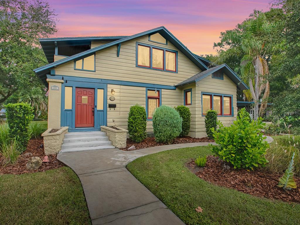 a front view of a house with a yard and porch