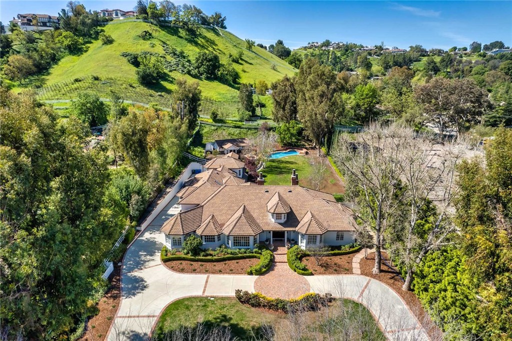 an aerial view of a house with yard swimming pool and outdoor seating