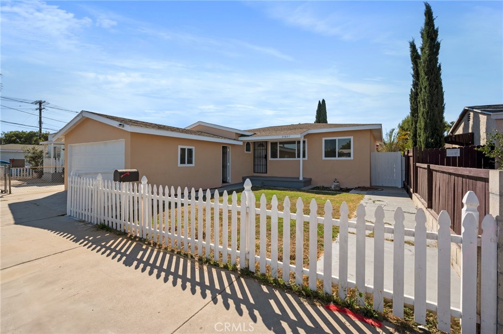 a front view of a house with wooden fence