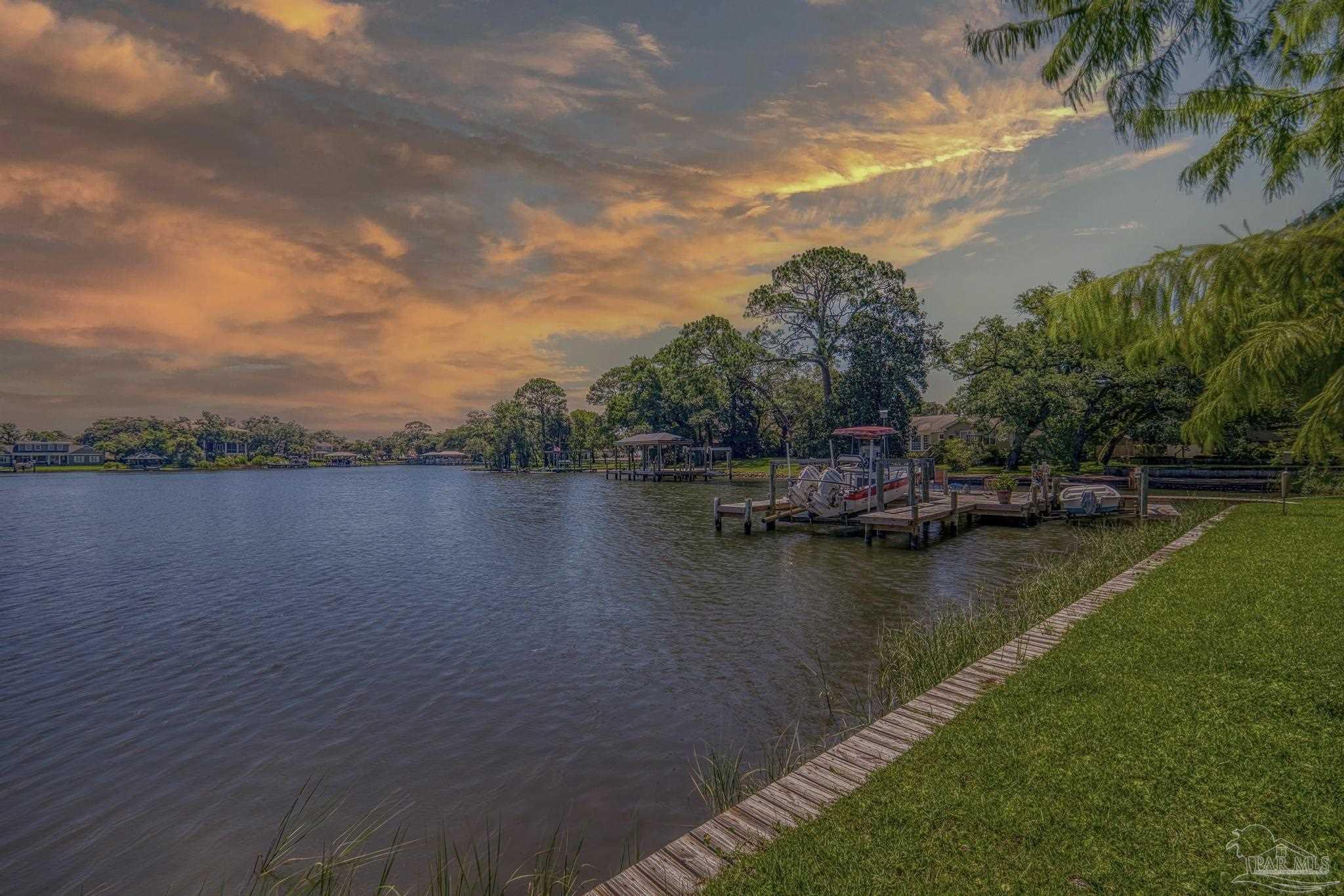 a view of a lake with houses in the back