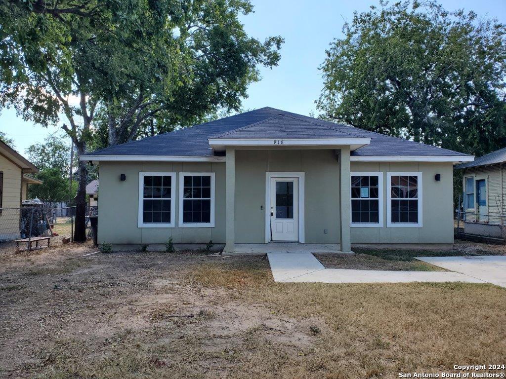 a house that has a tree in front of it