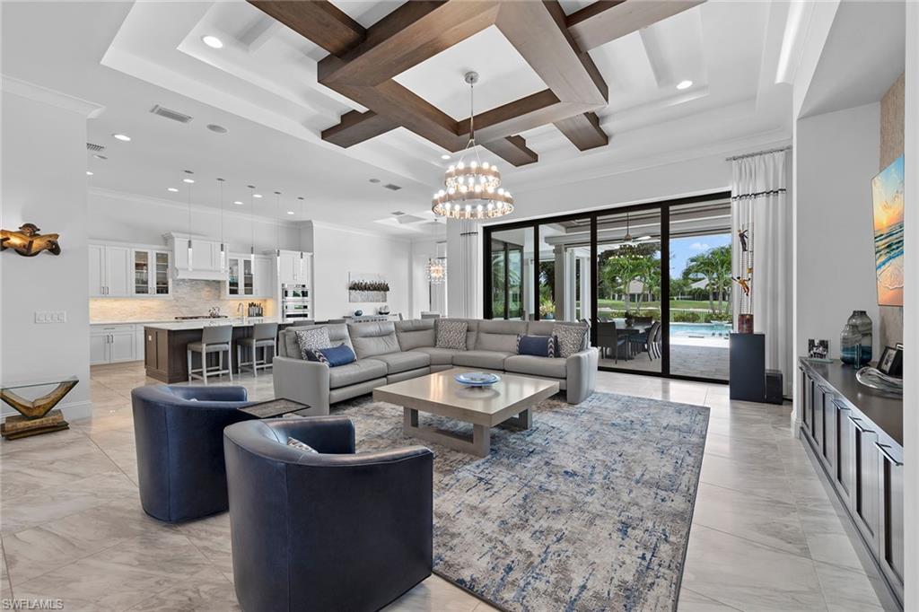 a dining room with stainless steel appliances granite countertop a couch and a view of living room