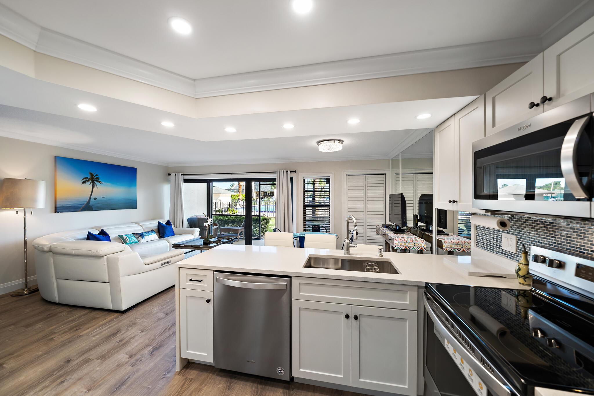 a kitchen with counter top space a sink stainless steel appliances and cabinets