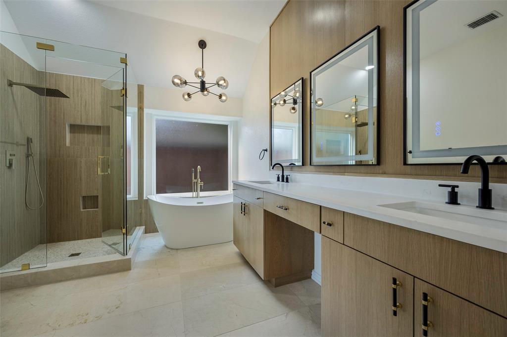 a bathroom with a double vanity sink toilet and shower