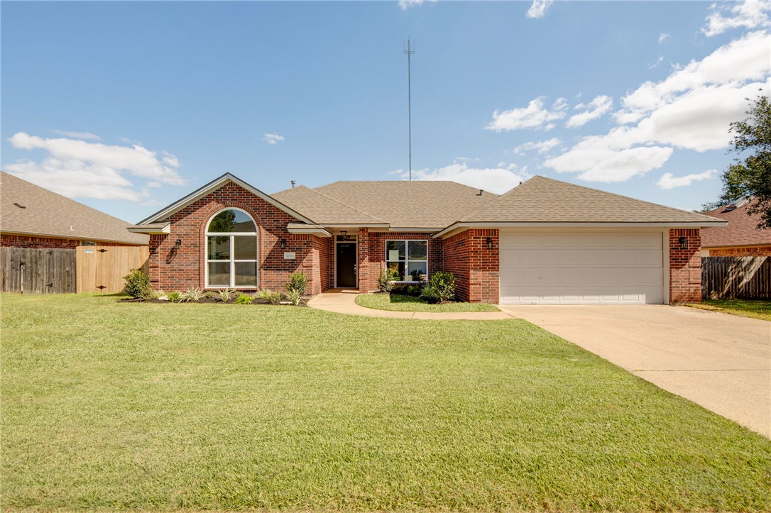 a front view of a house with a garden and deck