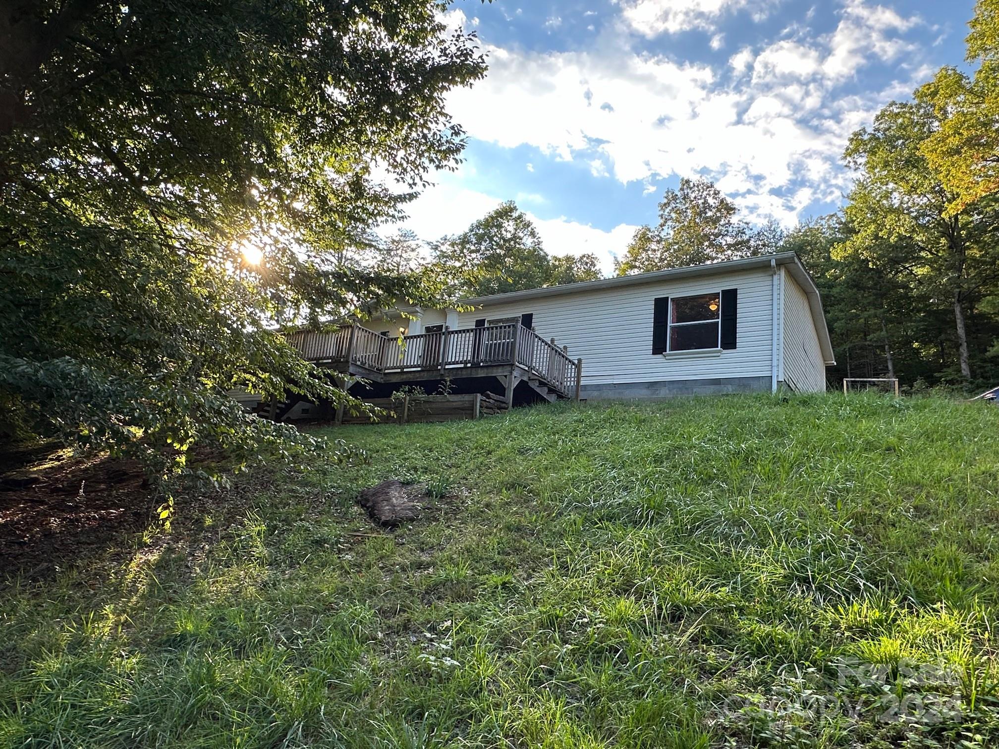 a view of a house with yard and a tree