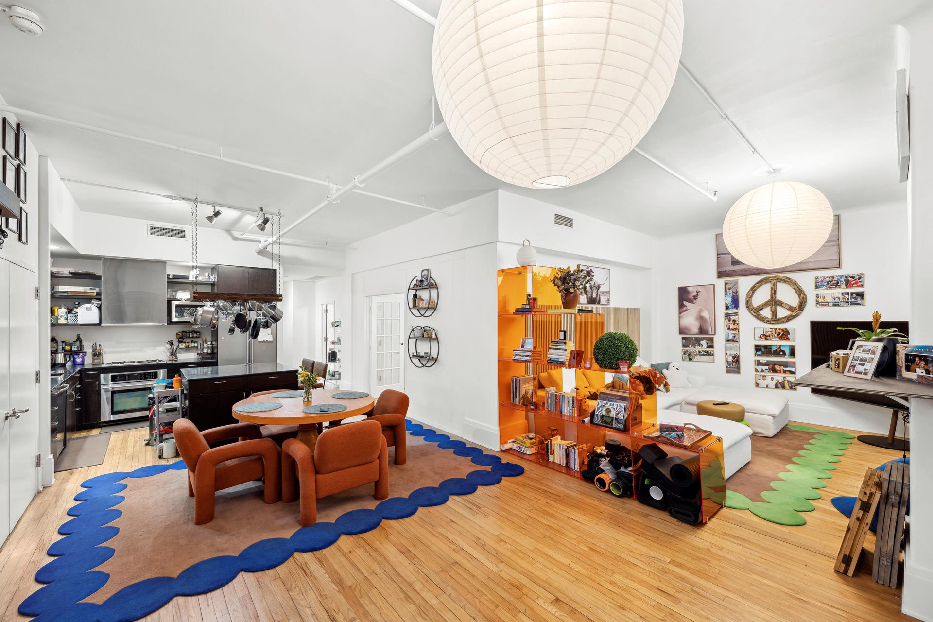 a living room with furniture a rug and a large mirror