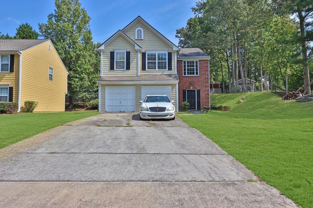 a front view of a house with a yard