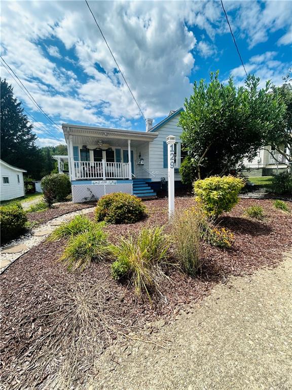 a front view of a house with garden