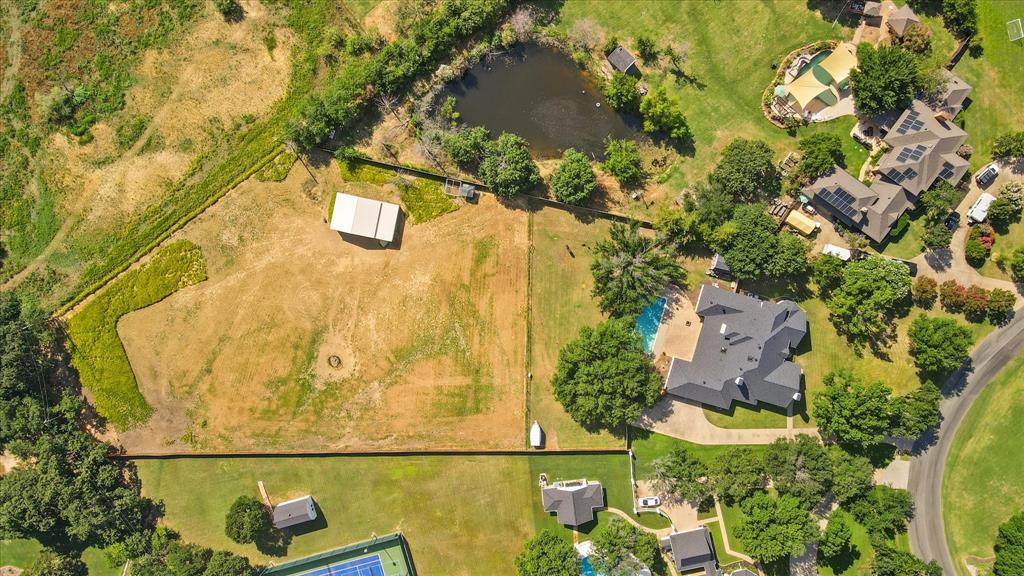 an aerial view of residential house with pool and garden