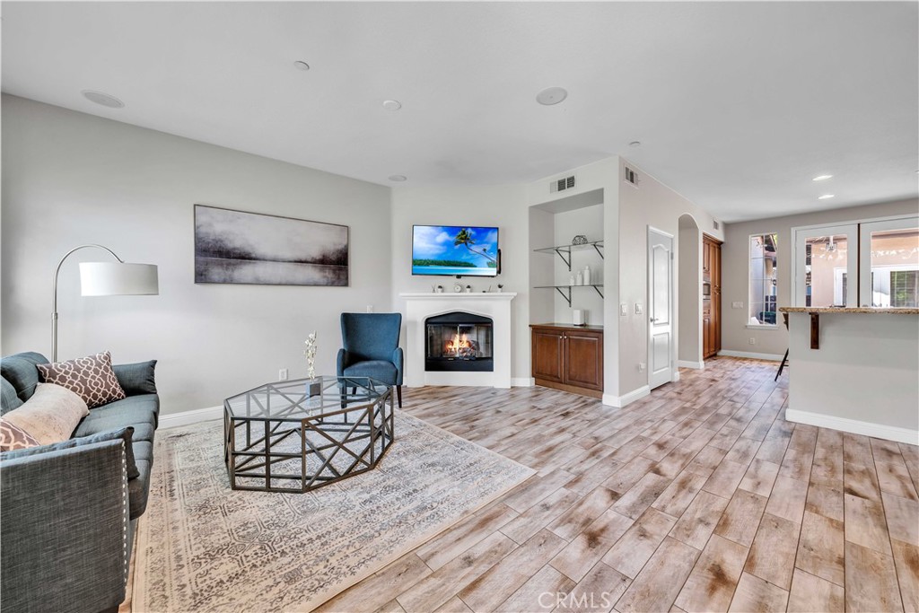 a living room with furniture a fireplace and a flat screen tv