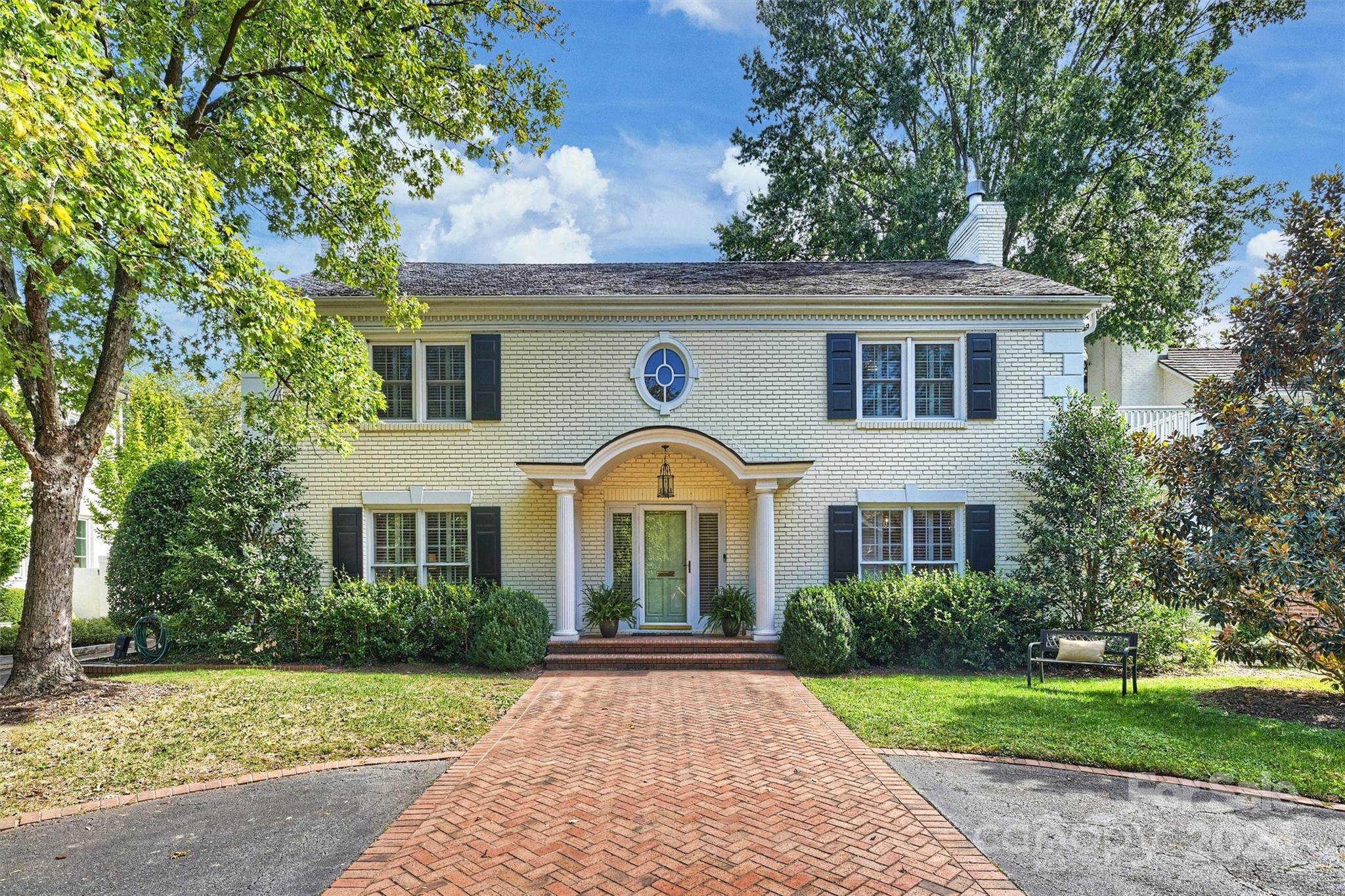 a front view of a house with garden