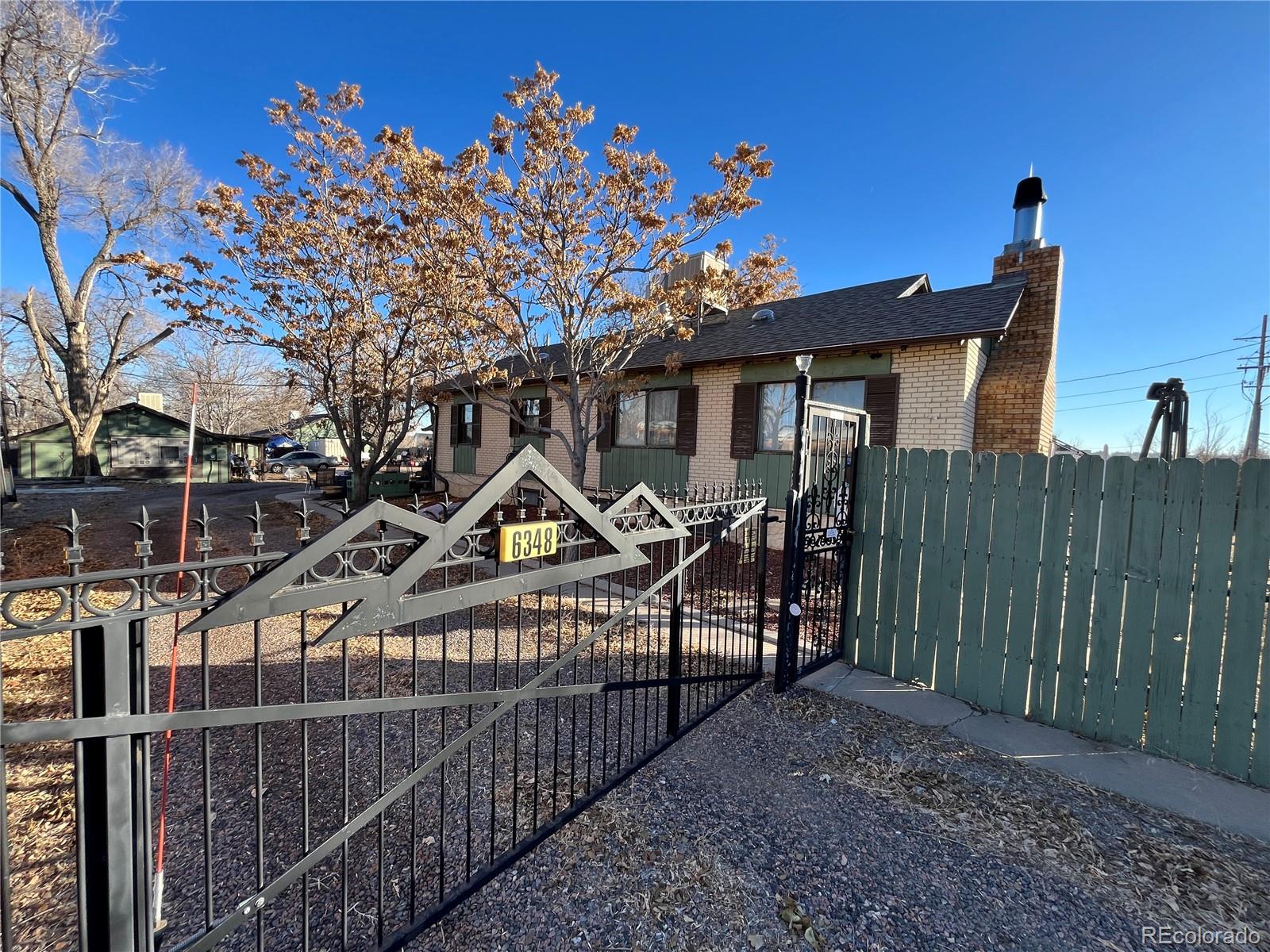 a view of a house with wooden fence