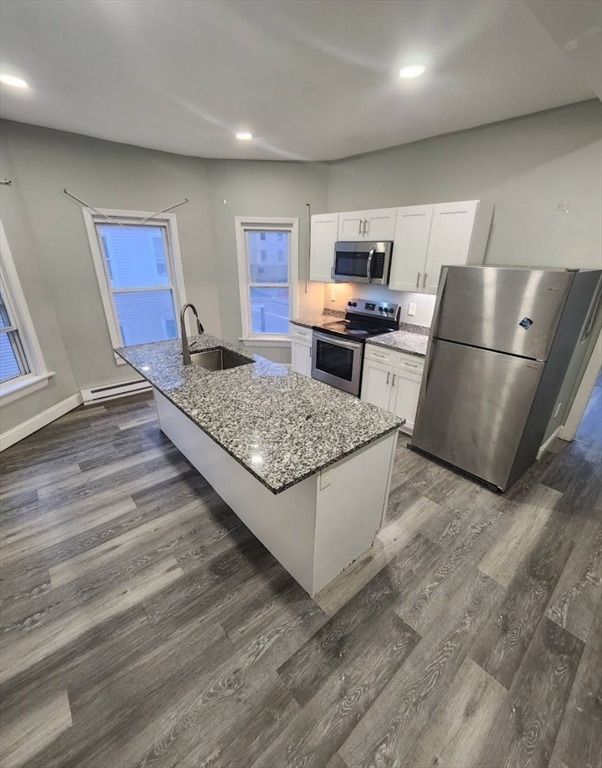 a kitchen with stainless steel appliances granite countertop a refrigerator oven stove a sink and dishwasher