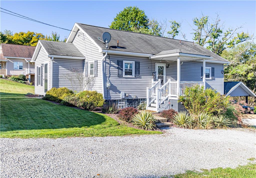 a front view of a house with a yard and outdoor seating