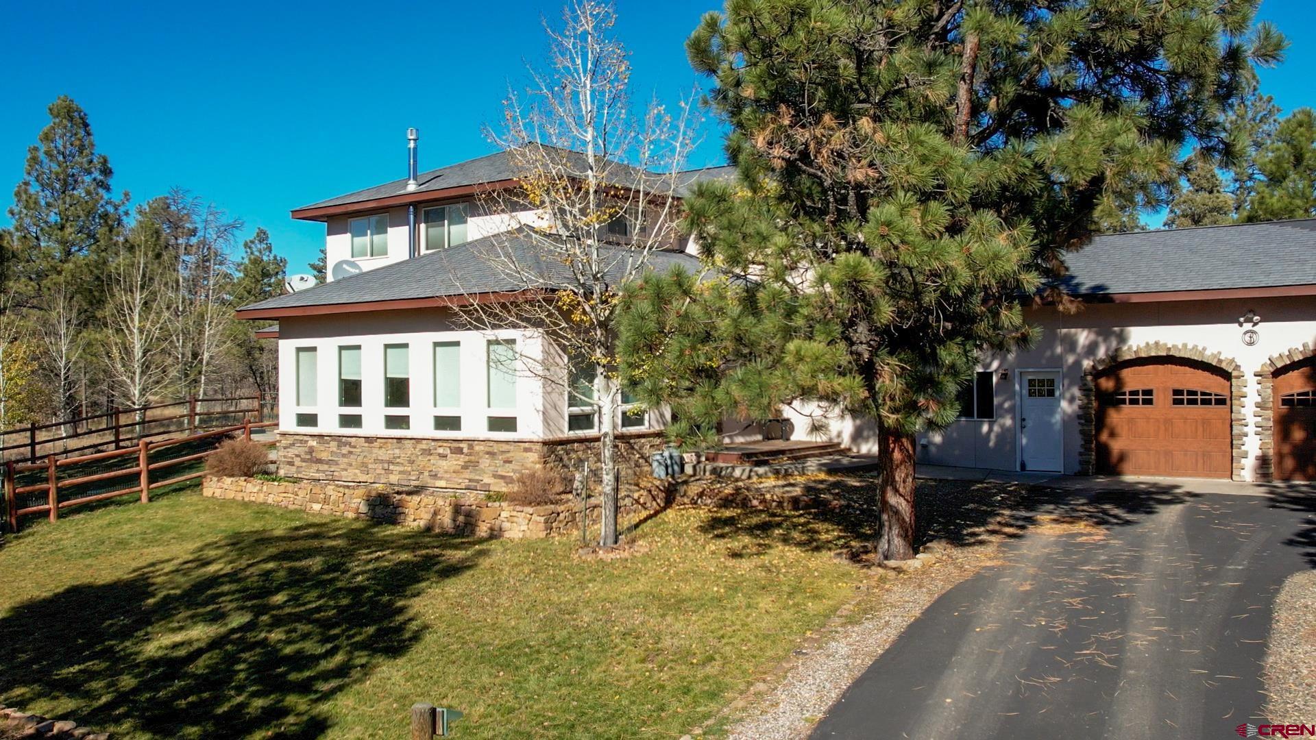 a view of a house with a yard covered with snow in the background