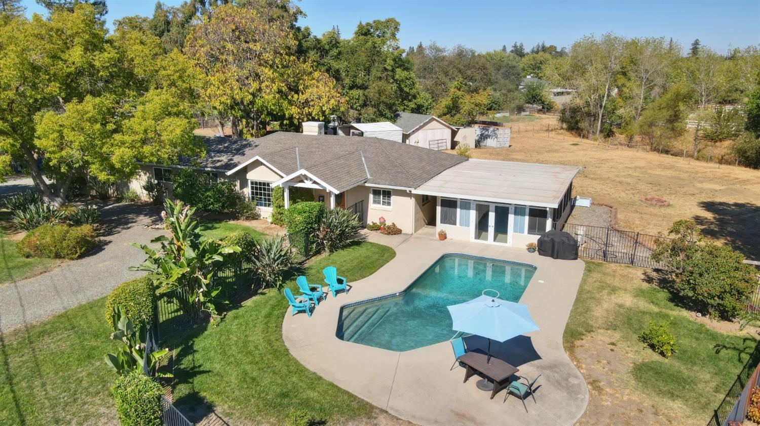 an aerial view of a house with a yard and trees