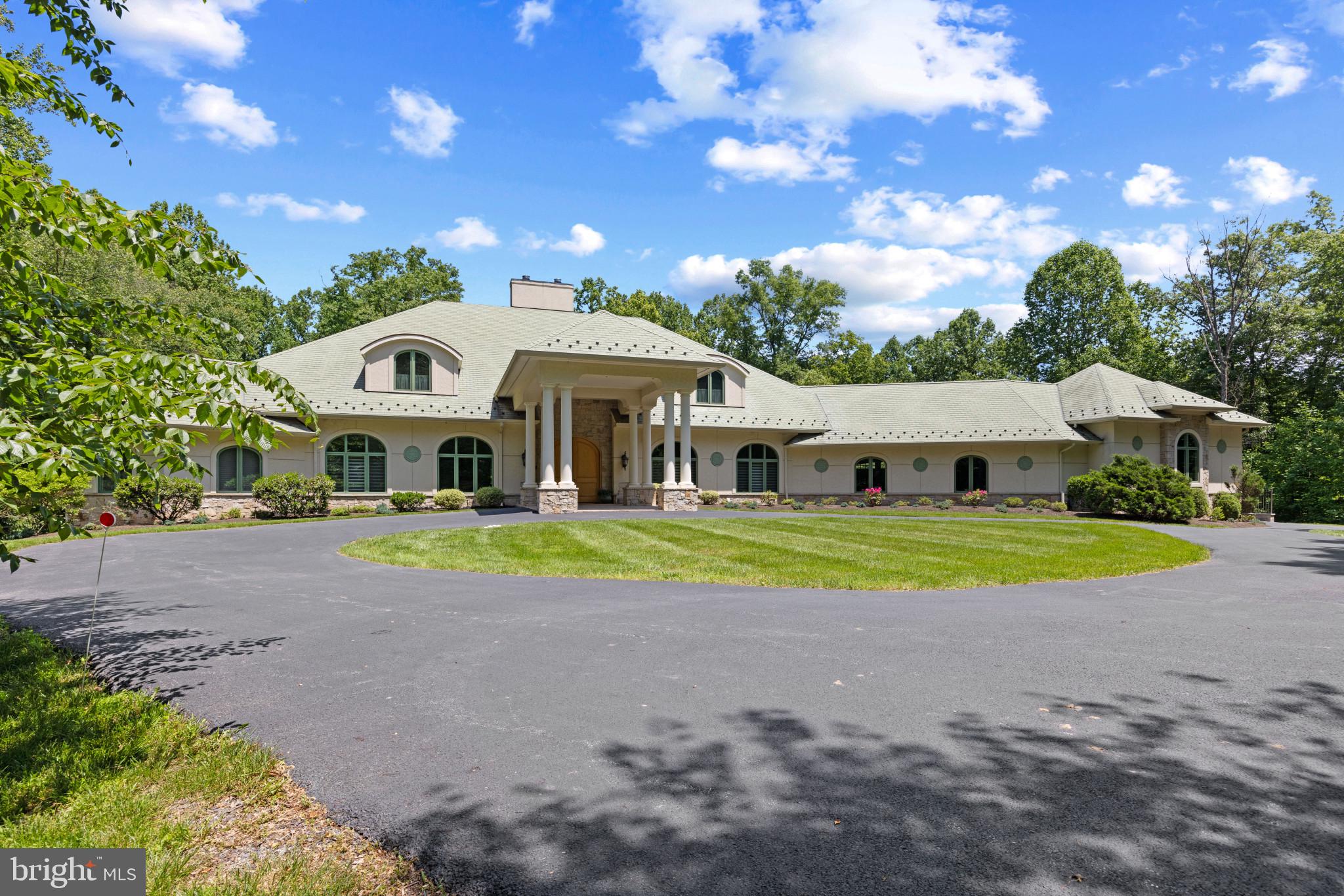 a front view of house with yard and trees