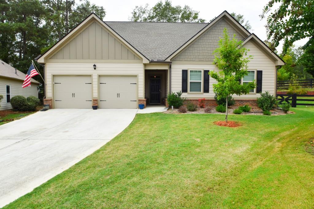 a view of a house with a yard and sitting area