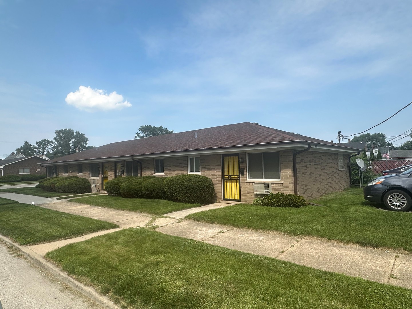 a front view of a house with a garden and yard