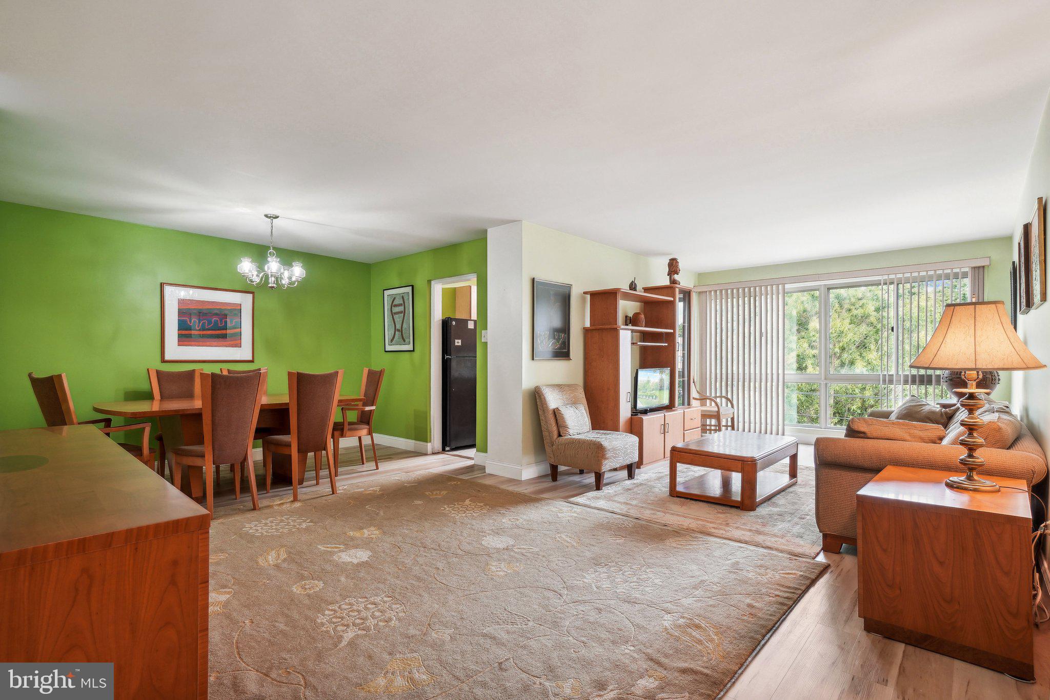 a living room with furniture and large windows